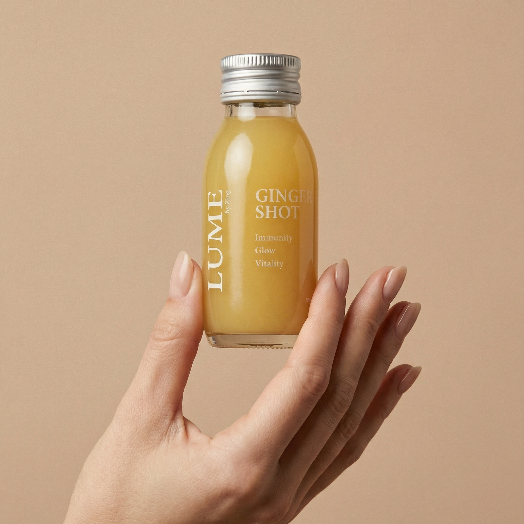 Hand holding a LUME ginger shot bottle — smooth 60ml daily wellness shot, Hong Kong