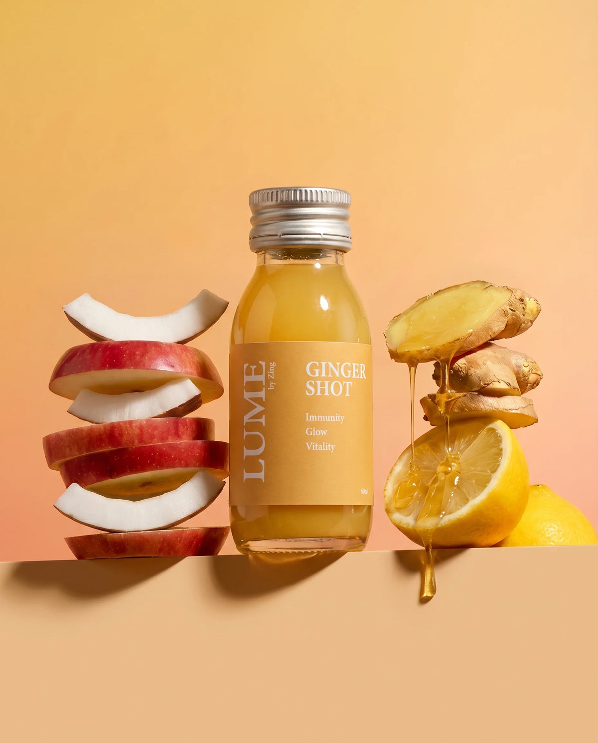 LUME Ginger Shot bottle with fresh apple, coconut, ginger, and lemon, its core ingredients