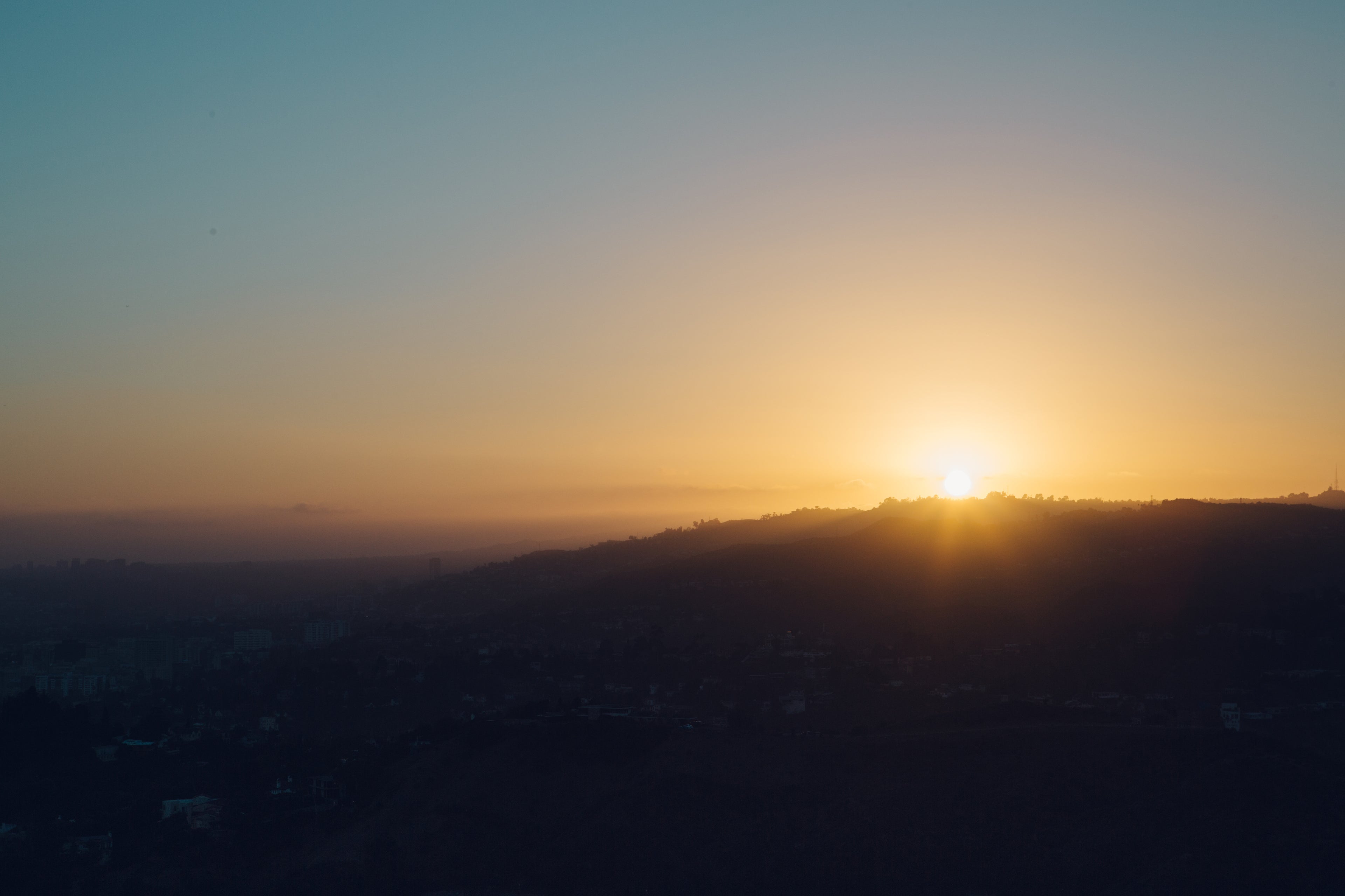 Sunrise over city hills — representing the start of a morning wellness routine
