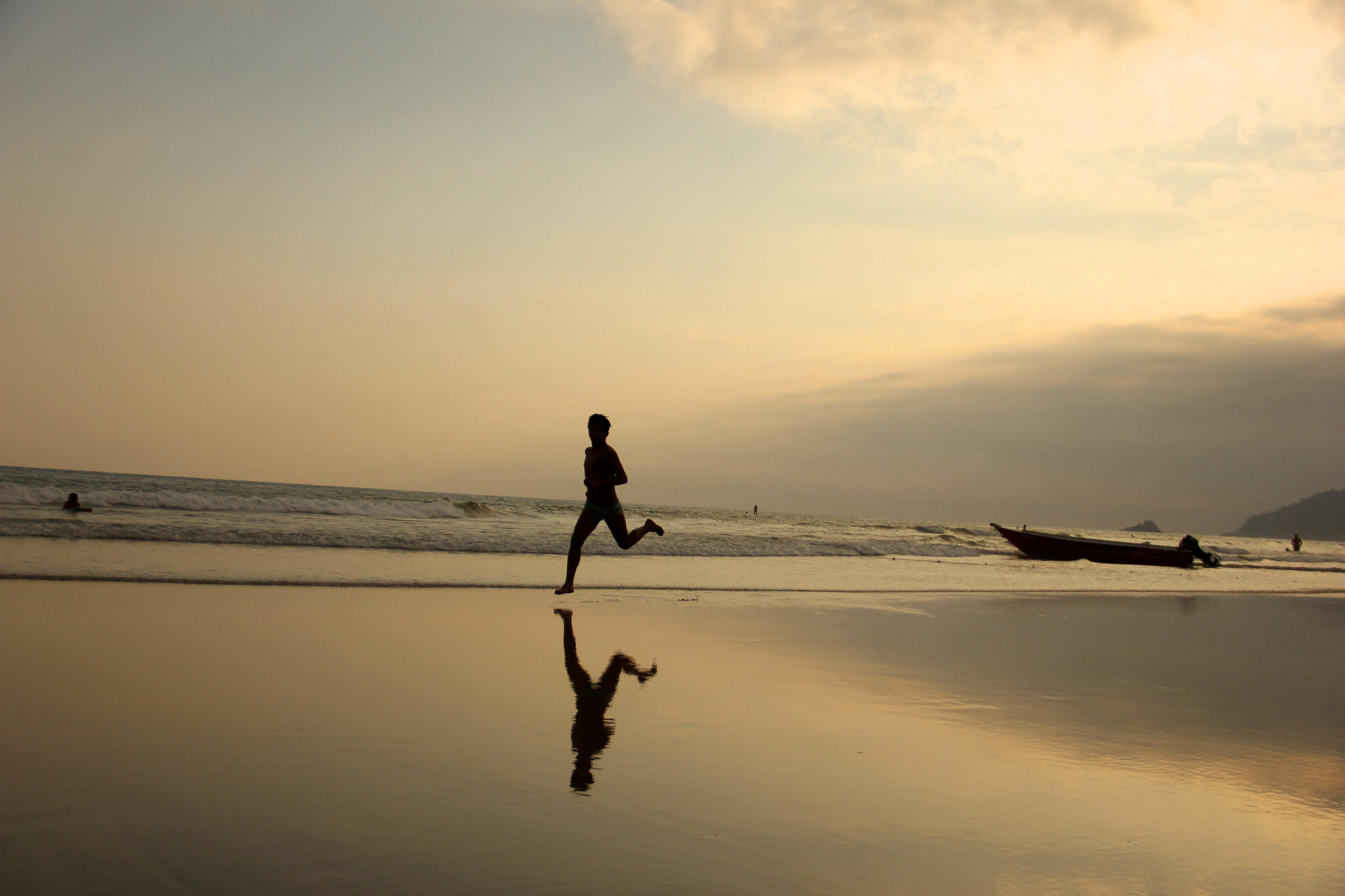 Person running on a beach at sunset — representing natural daily energy and vitality